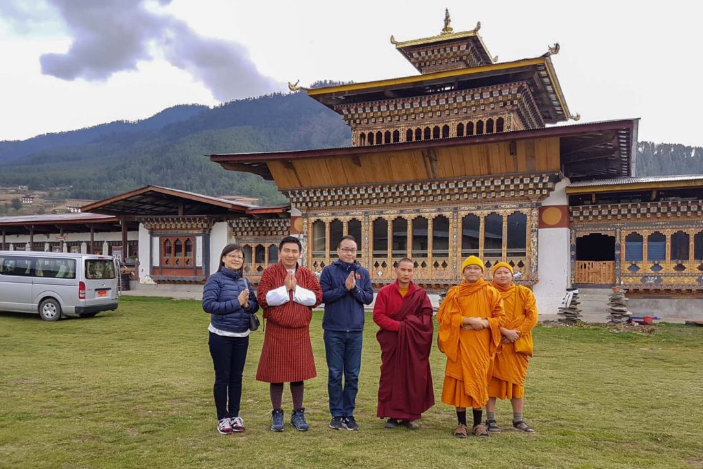 Guide and tourist with monk east Bhutan tour