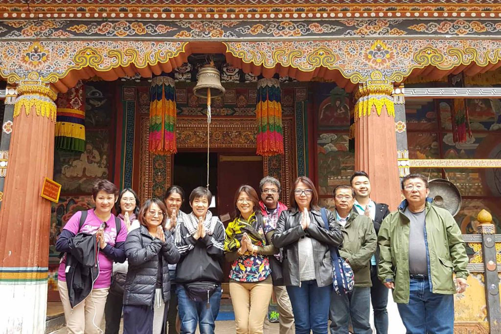 Guides and tourist in front of monastery east Bhutan tour