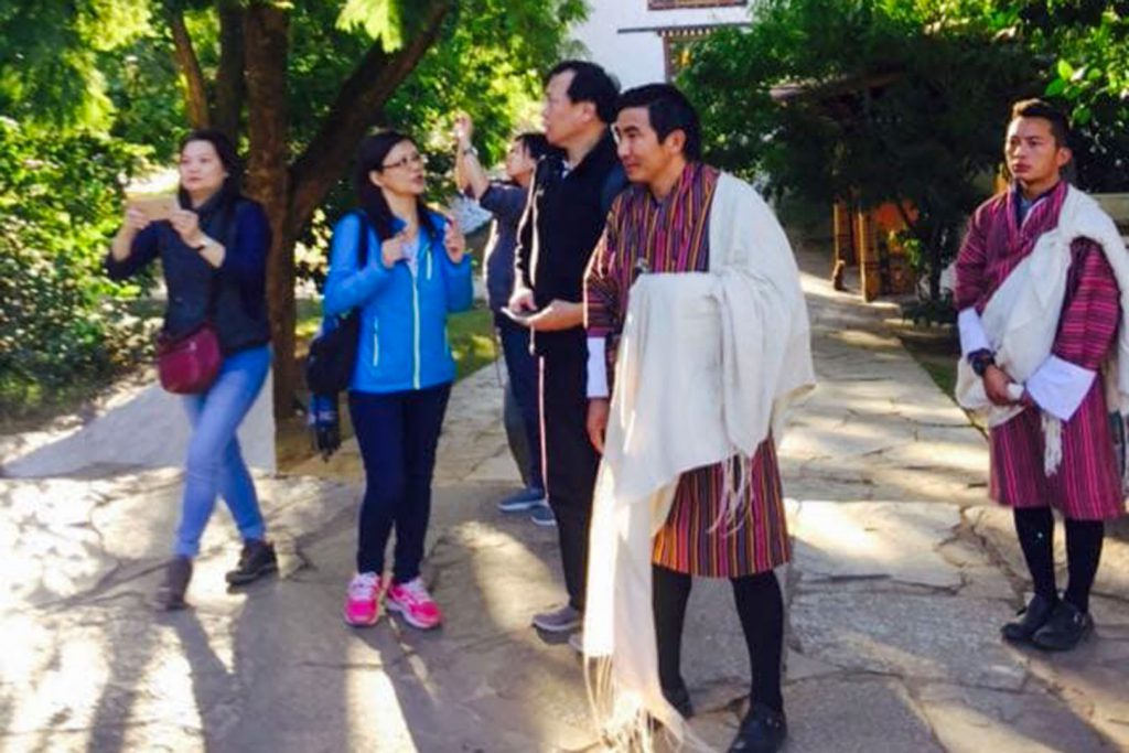 Guides with tourist eat Bhutan tour