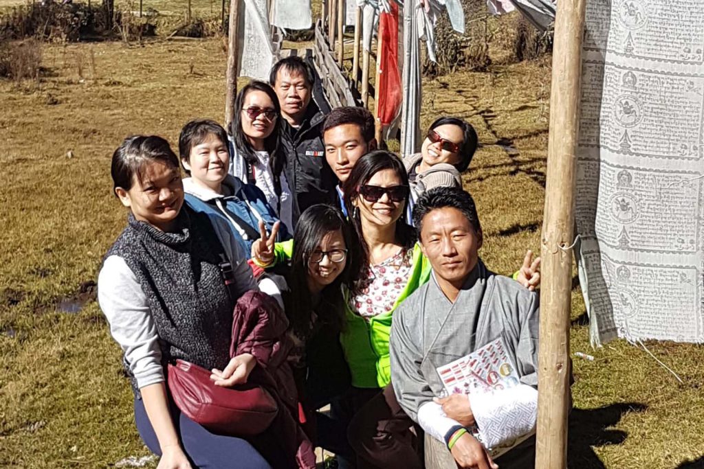 tourist and guide near player flags bumthang valley tour